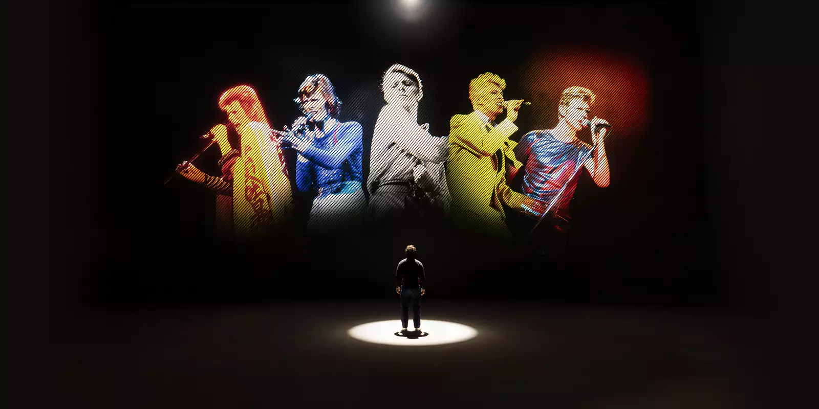 A person looking at five versions of David Bowie singing on a large screen