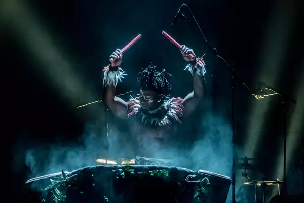 Photo of a performer playing drums on stage