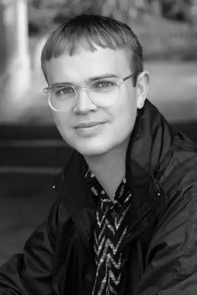 Headshot of Alexander Berlage outside with a blurred background