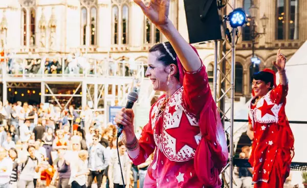 Woman on an outdoor stage holding a microphone