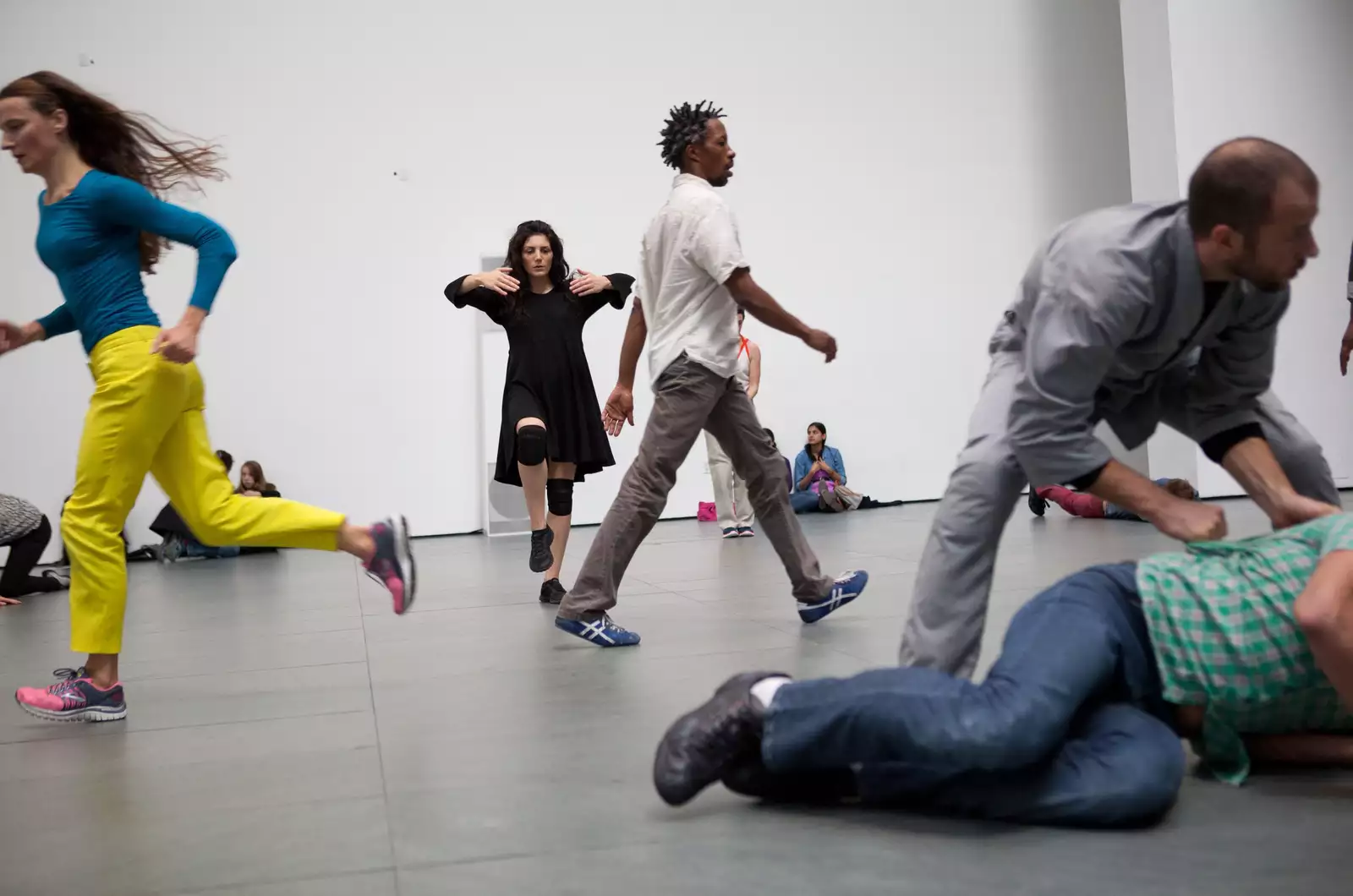 A group of dancers in a rehearsal space