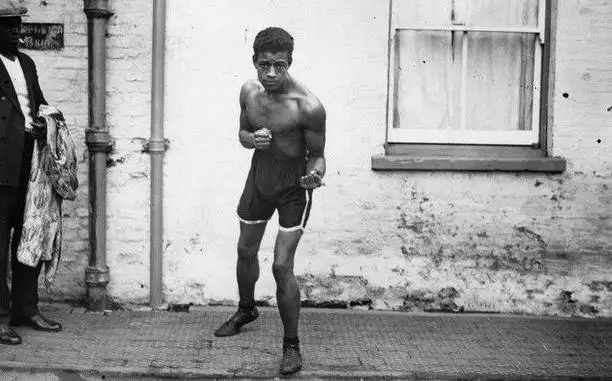 Black and white photograph of Len Johnson boxing