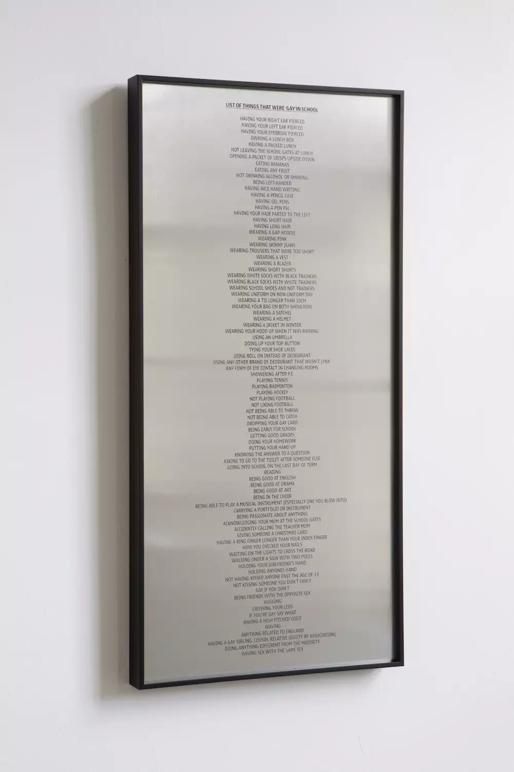 An artwork by Trackie McLeod showing a long list of slogans printed on aluminium