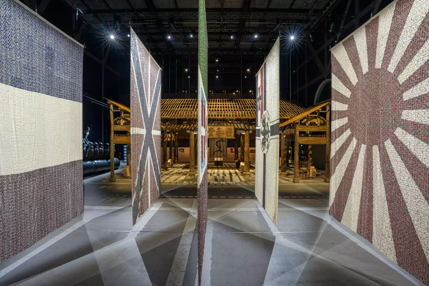 Five flags from the Eight-Nation Alliance Flags on display in the exhibition, with the Wang Family Ancestral Hall visible behind