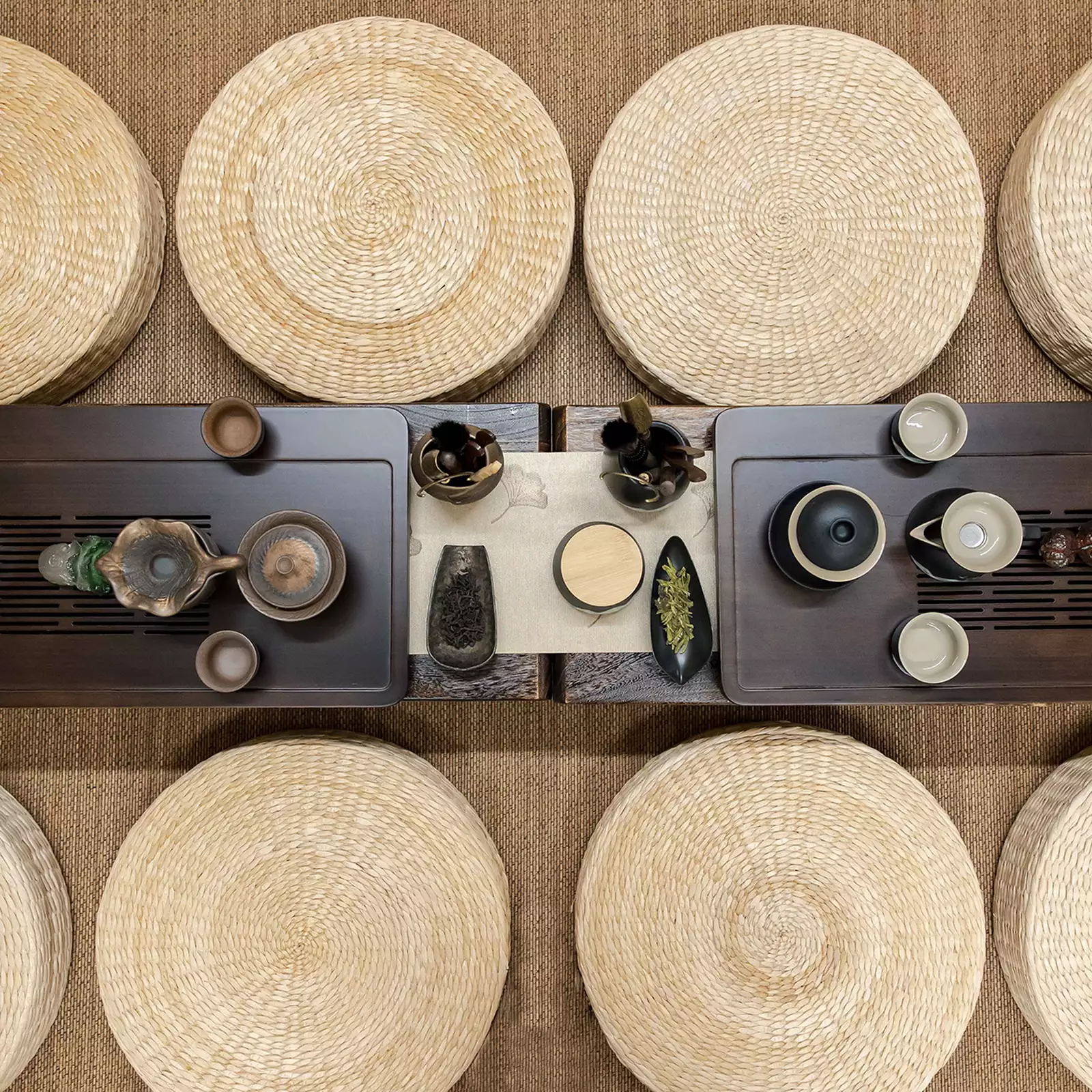 A traditional Chinese table laid with mats and tea pots
