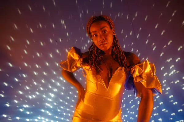 B!TEZ stands in front of a disco ball photographed by Marieke Macklon