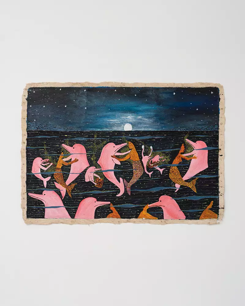 An artwork by Santiago Yahuarcani, showing dolphins and mermaids. The artwork is displayed on a white wall.