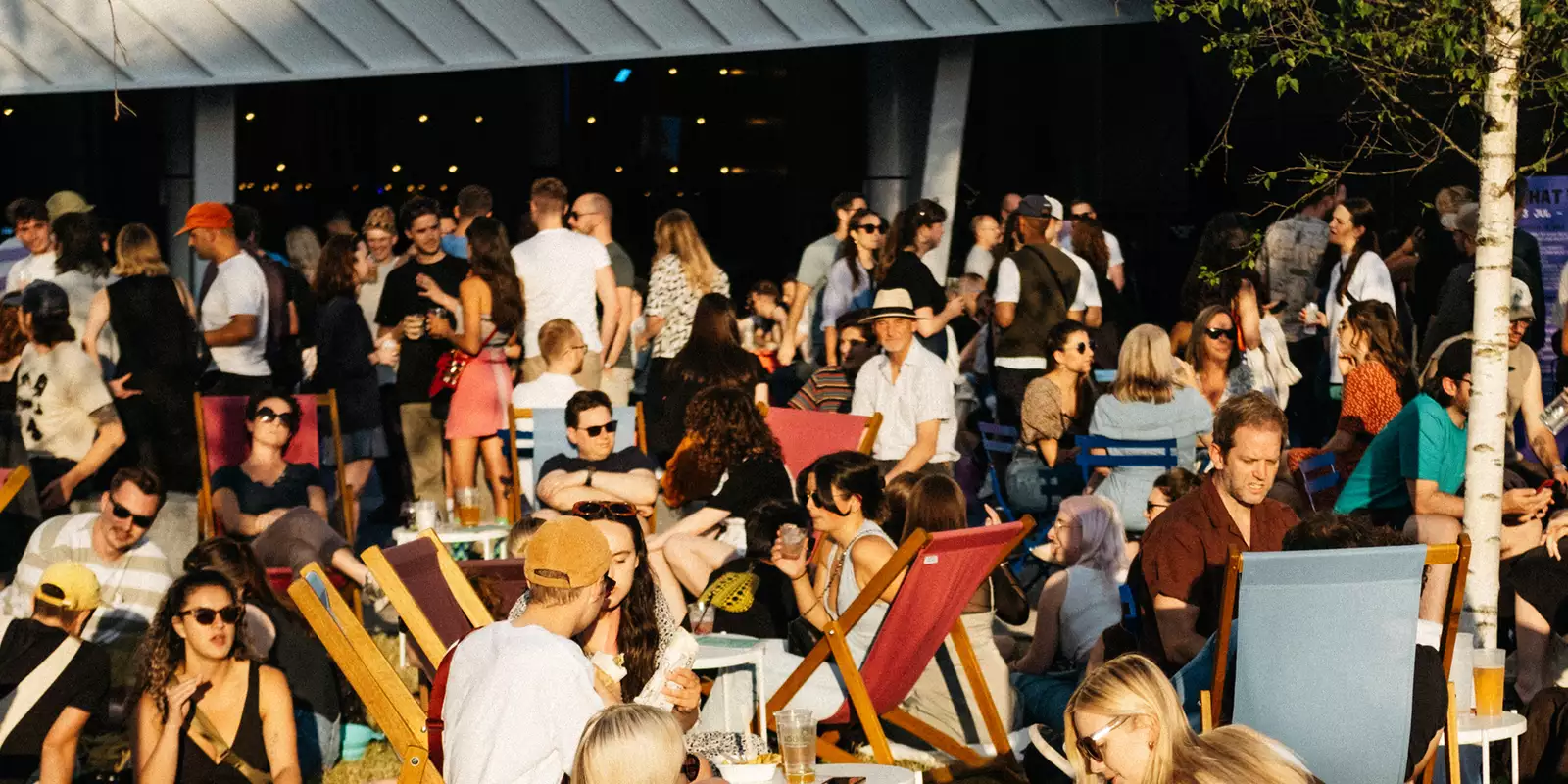 Photo of a busy crowd of people outside Aviva Studios on Festival Square during MIF23