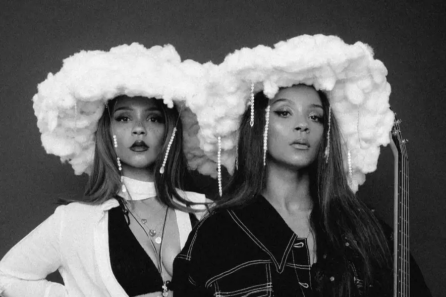 Black and white photo of the KTNA wearing white fluffy hats