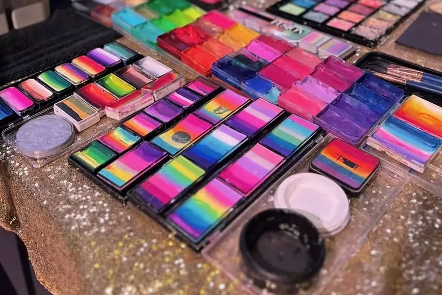 A selection of colourful face paints on a table