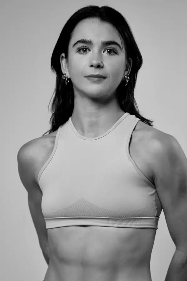 Black and white headshot of Felicity Chadwick wearing a white cropped top