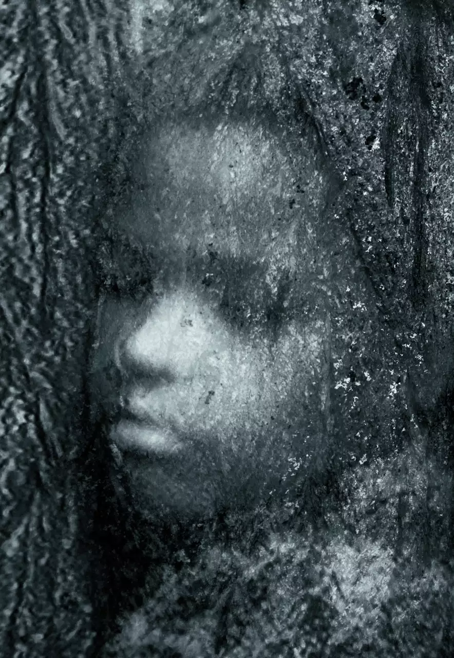 A black-and-white photograph of a child with their eyes closed behind an icy window
