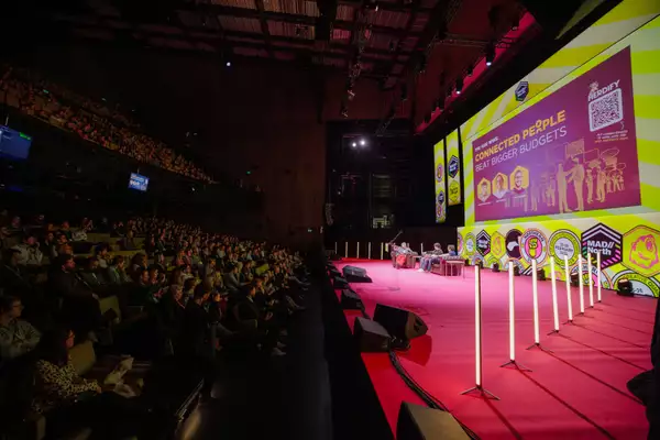 A large audience in the Hall watching a presentation on the stage