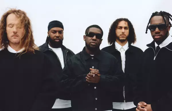 Five members of Ezra Collective on a white background