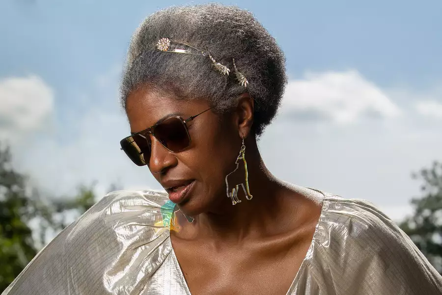 DJ Paulette wears a silver dress and sunglasses