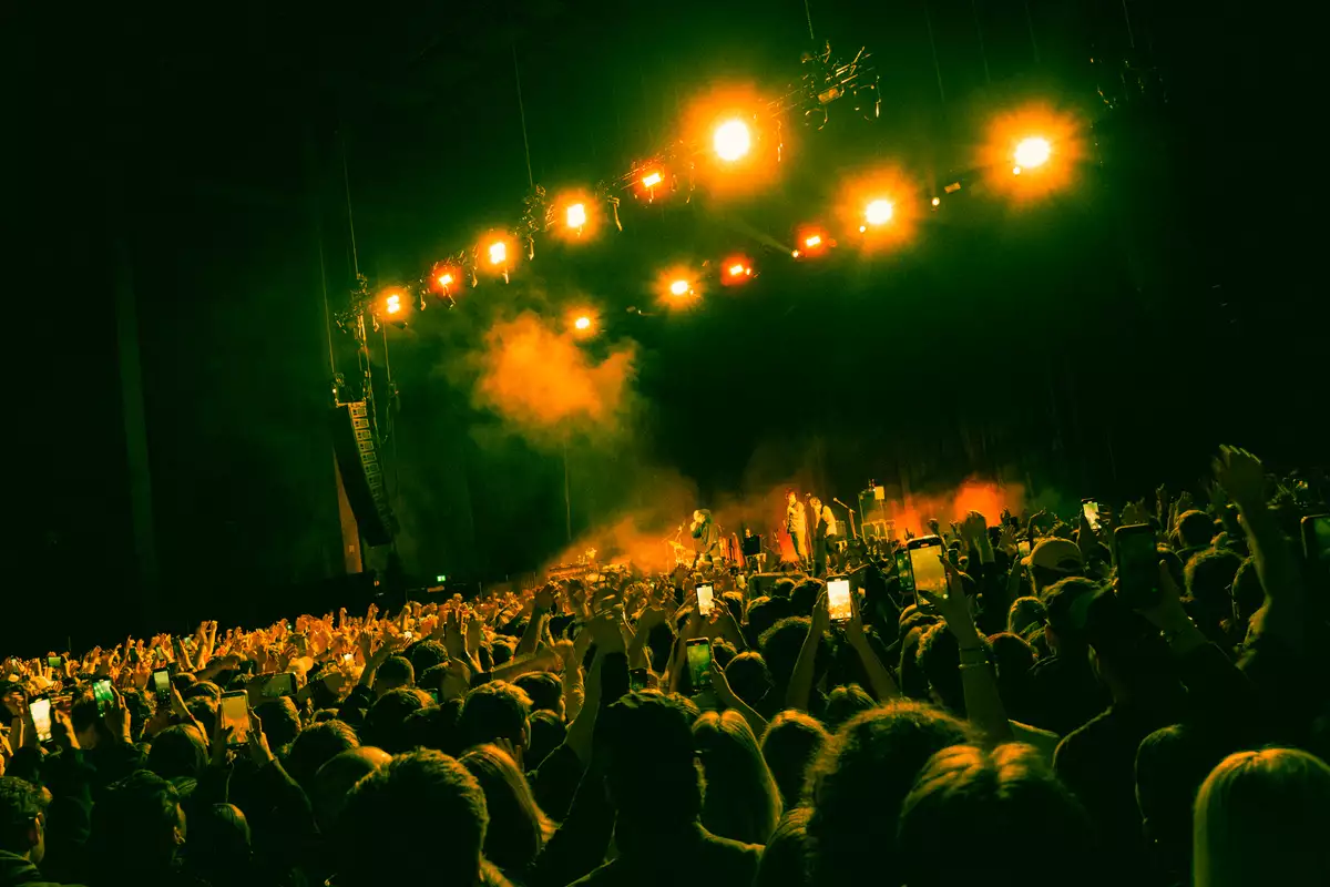 Large crowd of people in the Warehouse watching a gig and taking photos