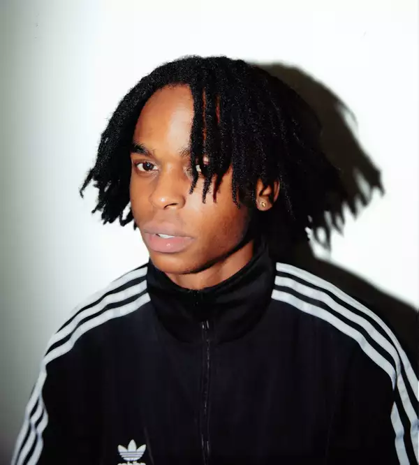 Anthony Namba wearing a black Adidas tracksuit top on a white background