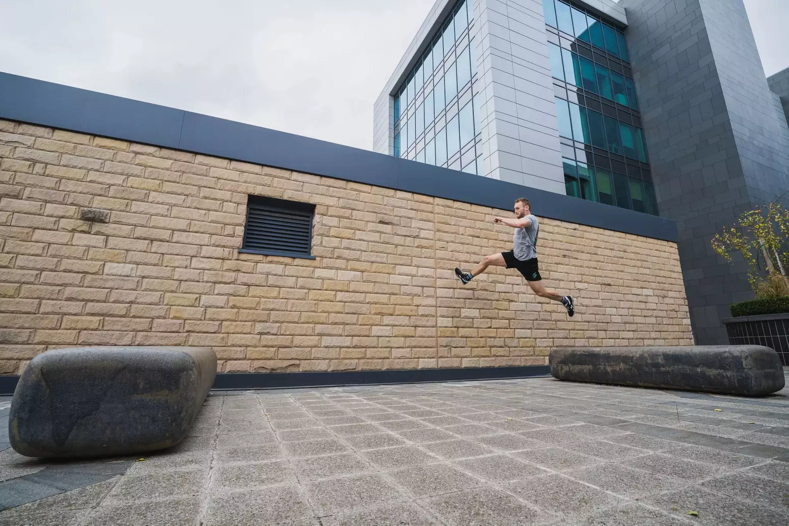 A person jumping between two stones outside