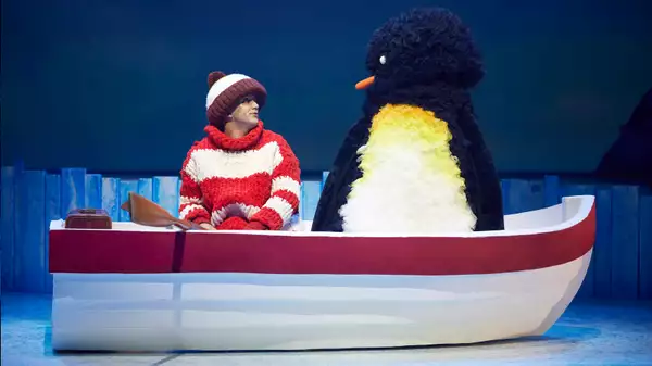 The boy and the penguin on stage for Lost and Found