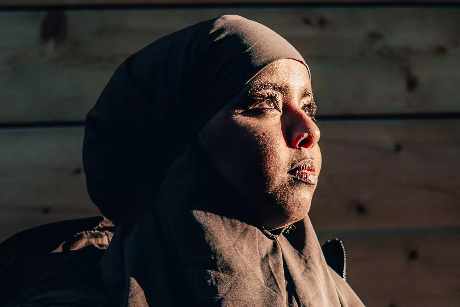 A close-up of Ebyan, this time not wearing a mask. The late afternoon sun illuminates her face.