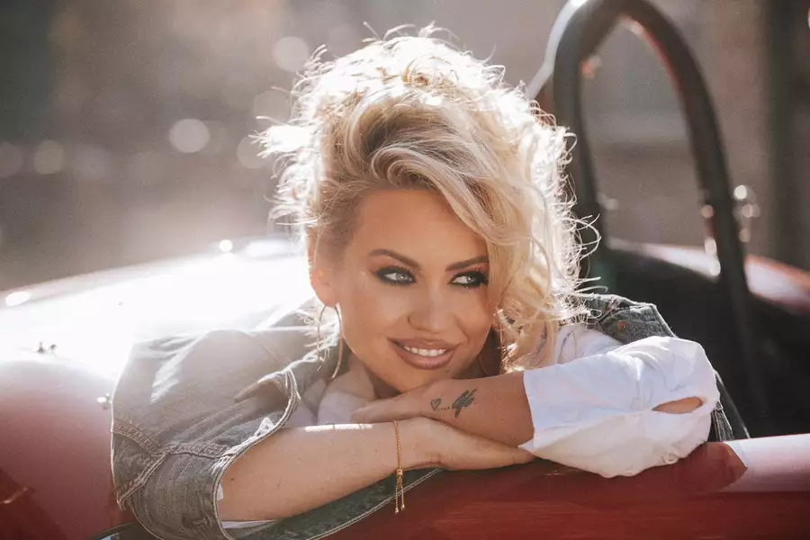 Kimberly Wyatt smiling in an open top ca