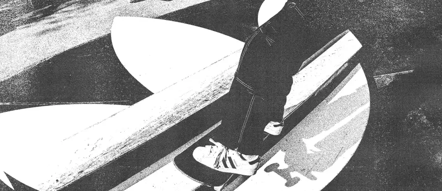 Black and white image of someone skateboarding on an Adidas skate ramp wearing Adidas trainers