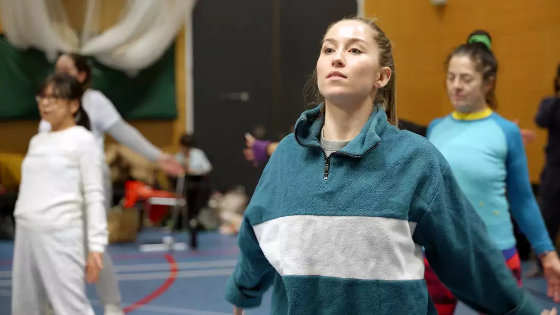 A participant performing in rehearsals