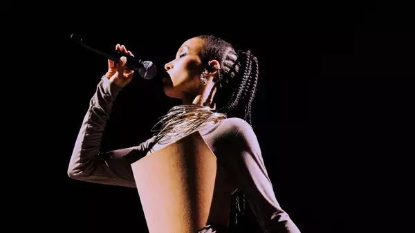 FKA twigs singing into a microphone