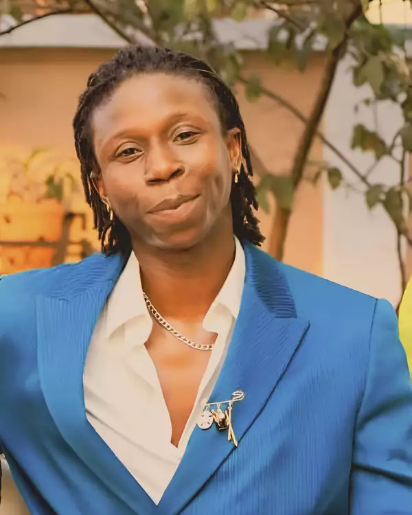 Christian Asare wearing a blue suit jacket and white shirt