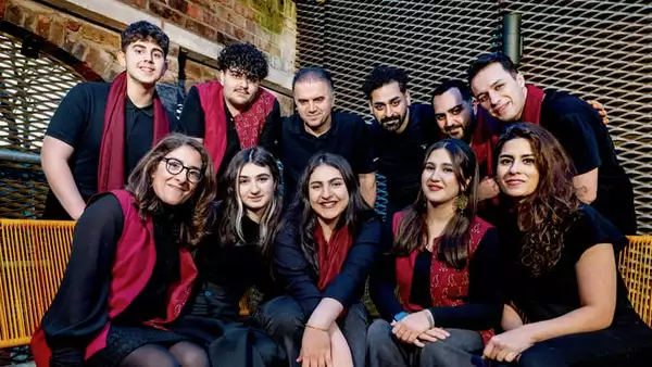 Group photo of Hamsaz Ensemble wearing black outfits with red scarves