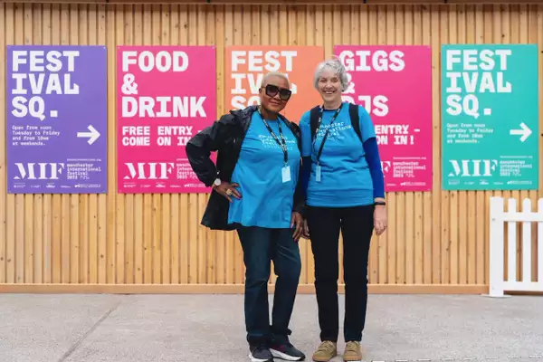 Photo of two volunteers on Festival Square