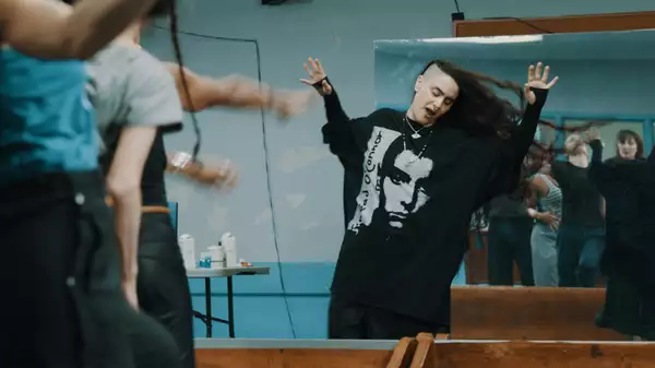 Still of Sonya Tayeh dancing in the rehearsal room while the dancers watch
